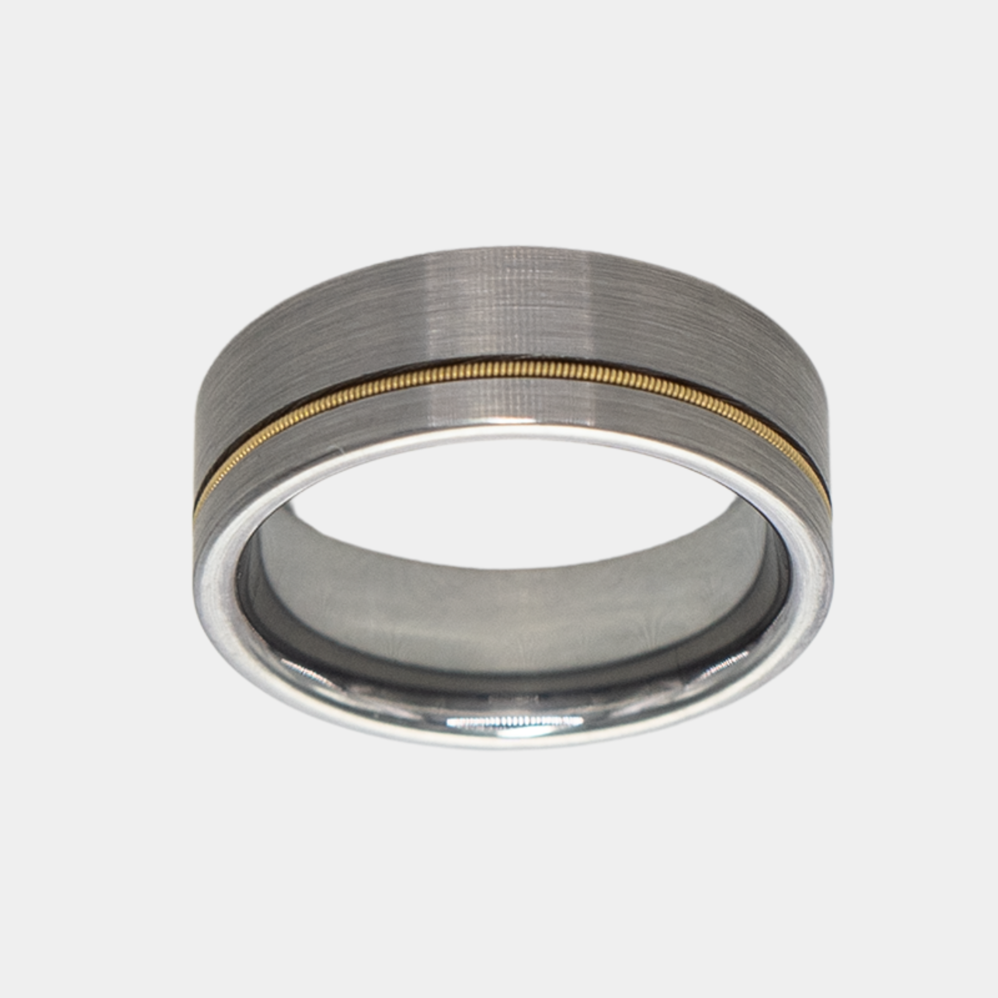 Orpheus ring – Brushed Silver Tungsten with Gold Guitar String Inlay from The Hustler Collection. Top-down view showcasing ring face.