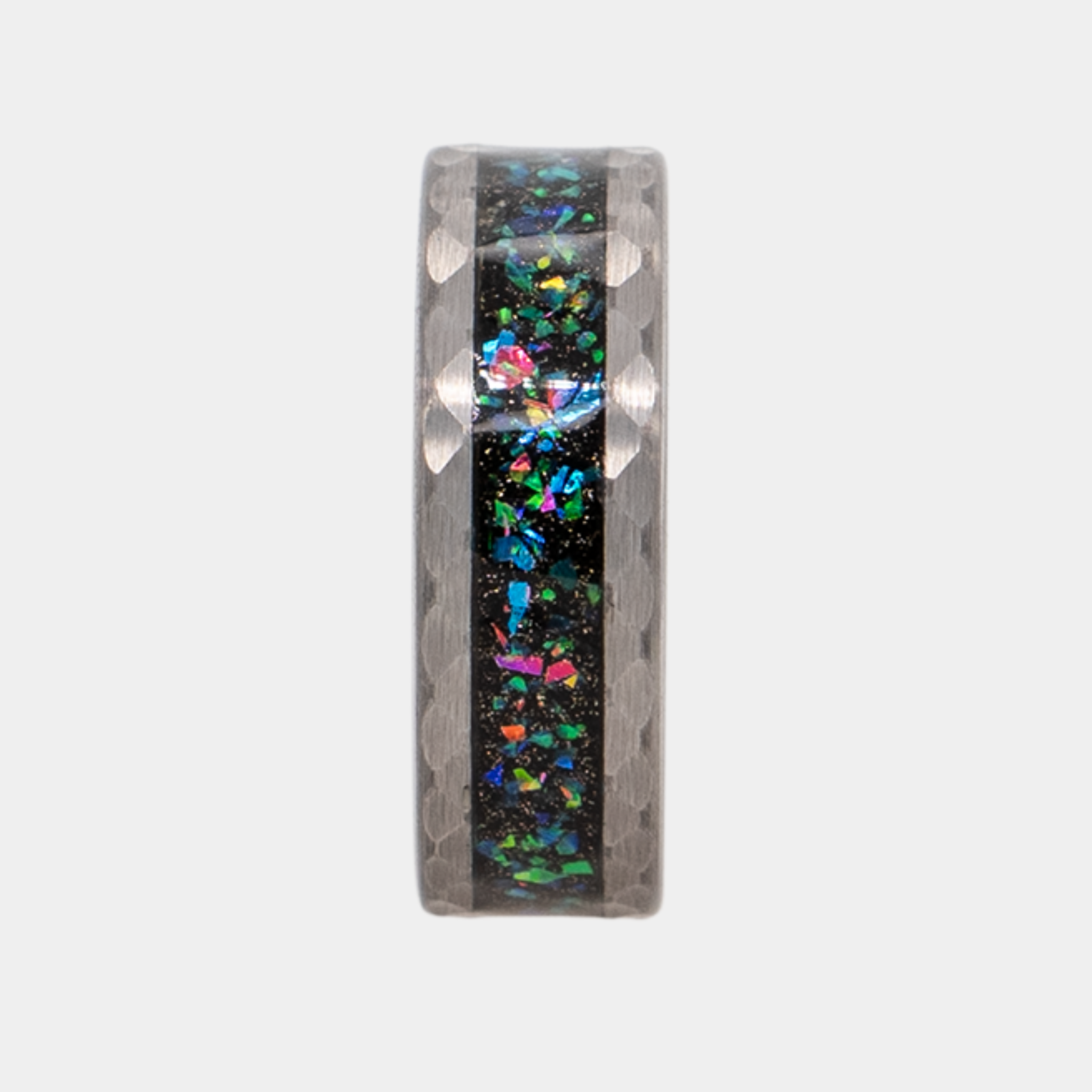 Typhon ring – Hammered Silver Tungsten featuring a Crushed Opal Inlay from the Hustler Collection. Ring standing upright to show profile and thickness.