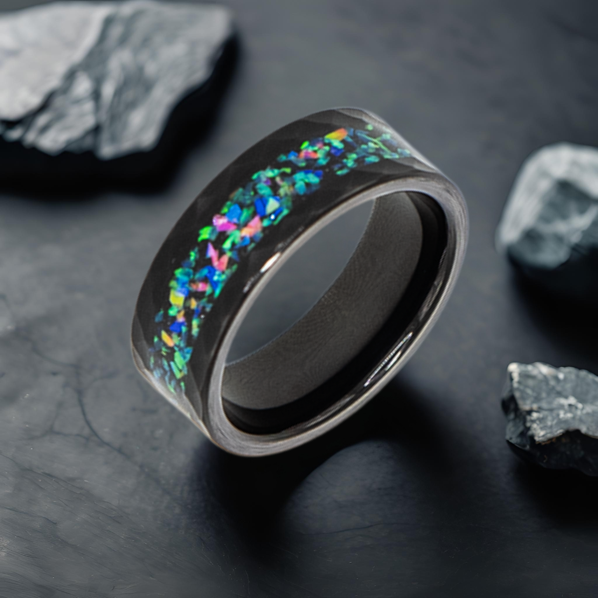 Aeolus ring – solid black diamond with polished beveled edges from the Hustler Collection. Lifestyle shot, placed on textured marble.