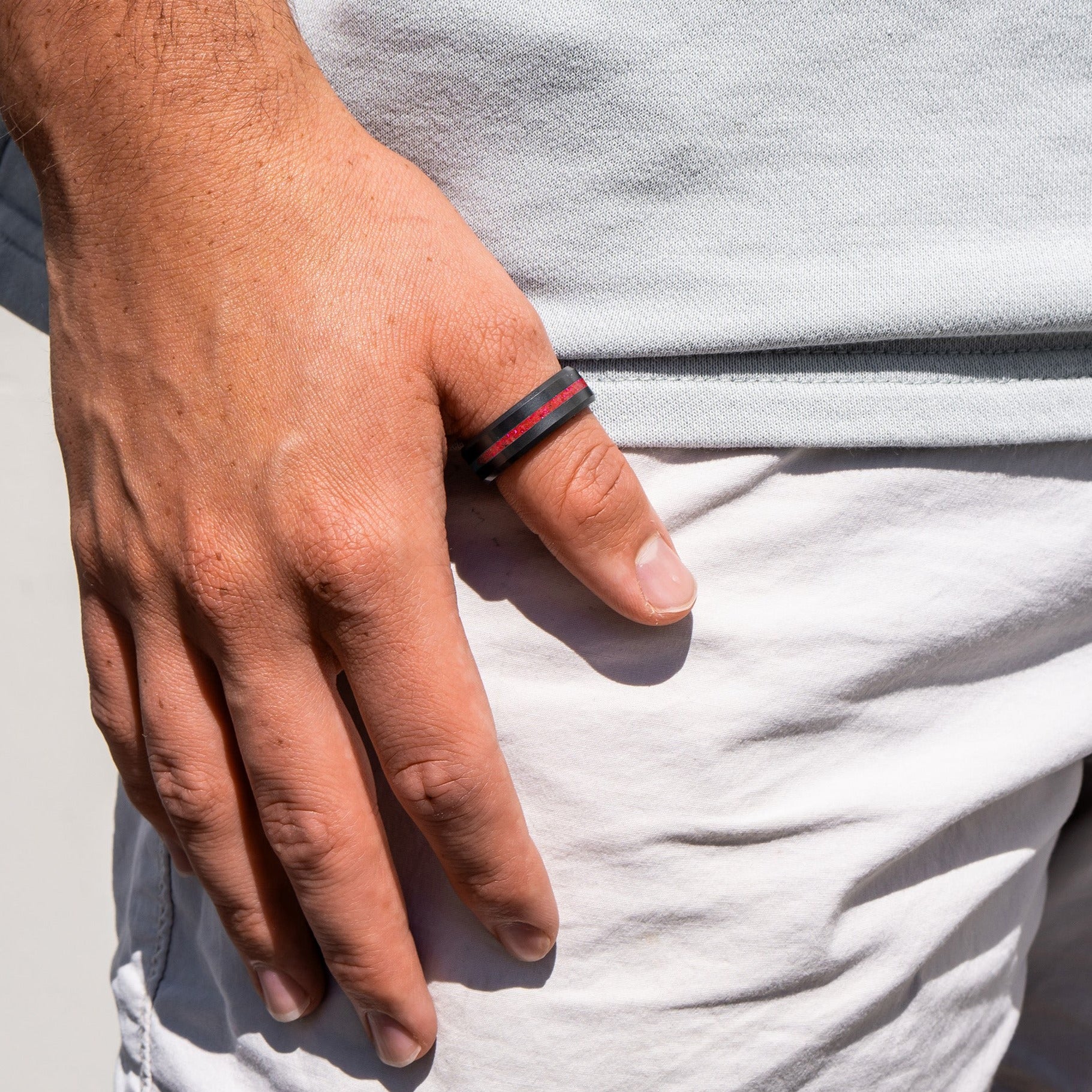 Lifestyle shot #2 of men's hands wearing our Elysium ARES Men's Black Diamond & Red Opal ring | ElysiumBlack.com | Men’s Opal Rings | Opal Rings for Men