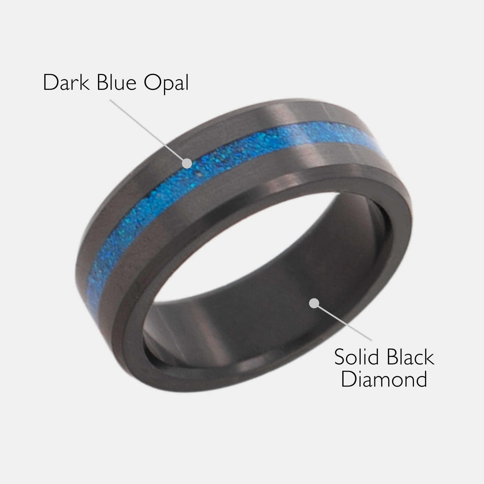 Solid Black Diamond ring with dark blue opal inlay on a grey background