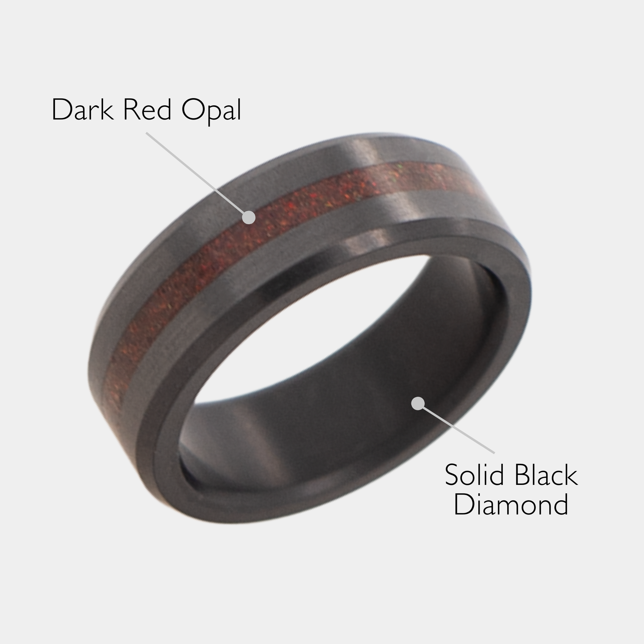 Solid Black Diamond ring with dark red opal inlay on a grey background