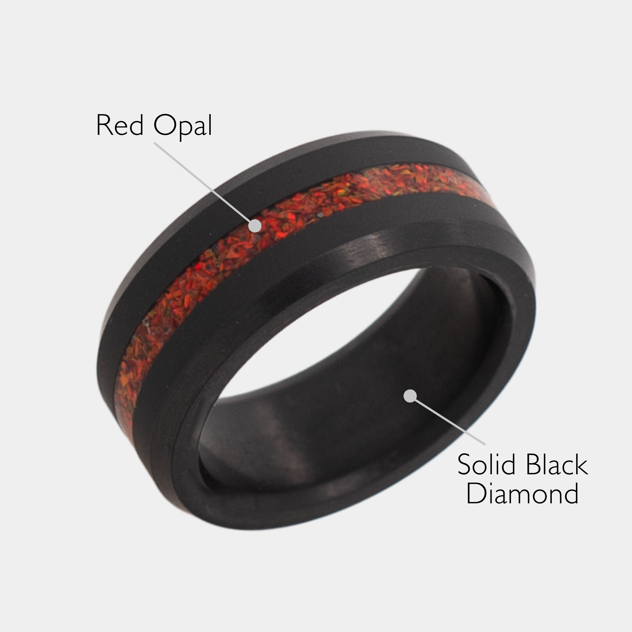 Solid Black Diamond ring with red opal inlay on a grey background